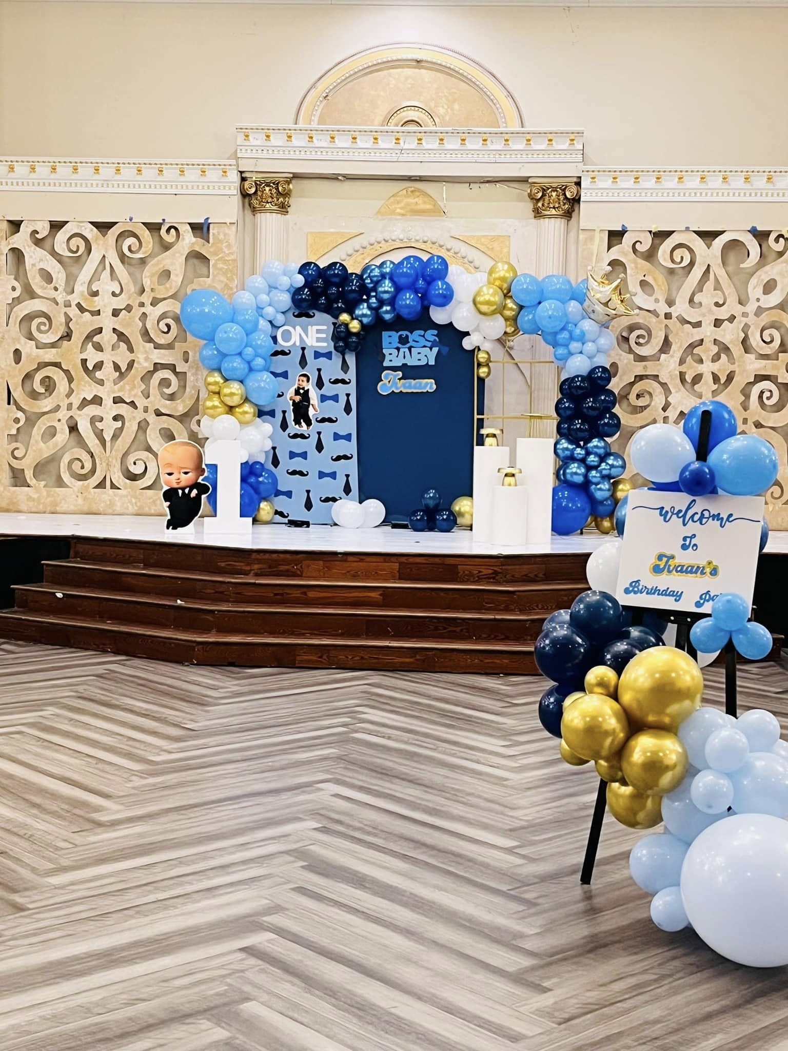 Boss Baby birthday — blue and gold balloon arch
