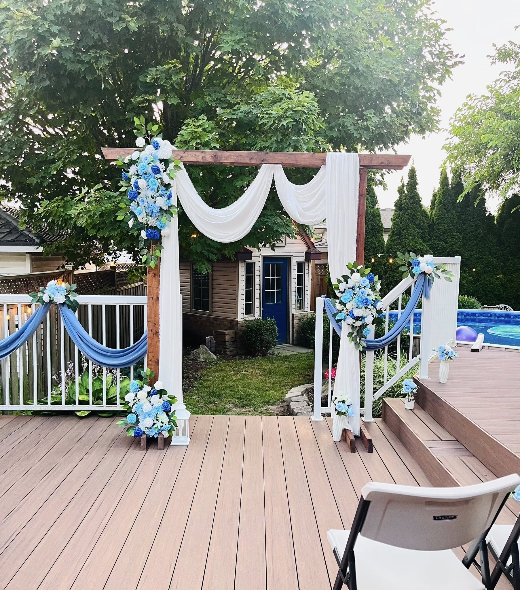 Outdoor wedding arch — blue and white flowers on wooden pergola