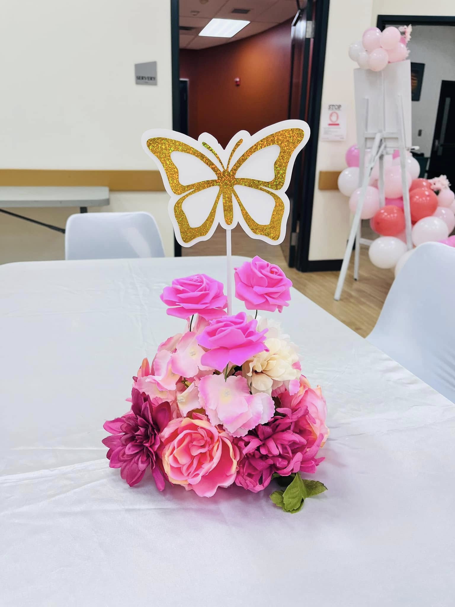 Pink flower centerpiece with gold butterfly